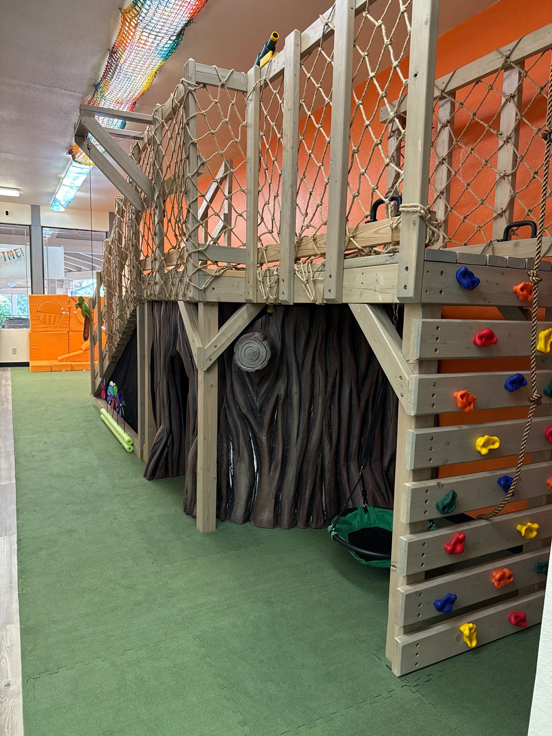Children climbing wooden play structure