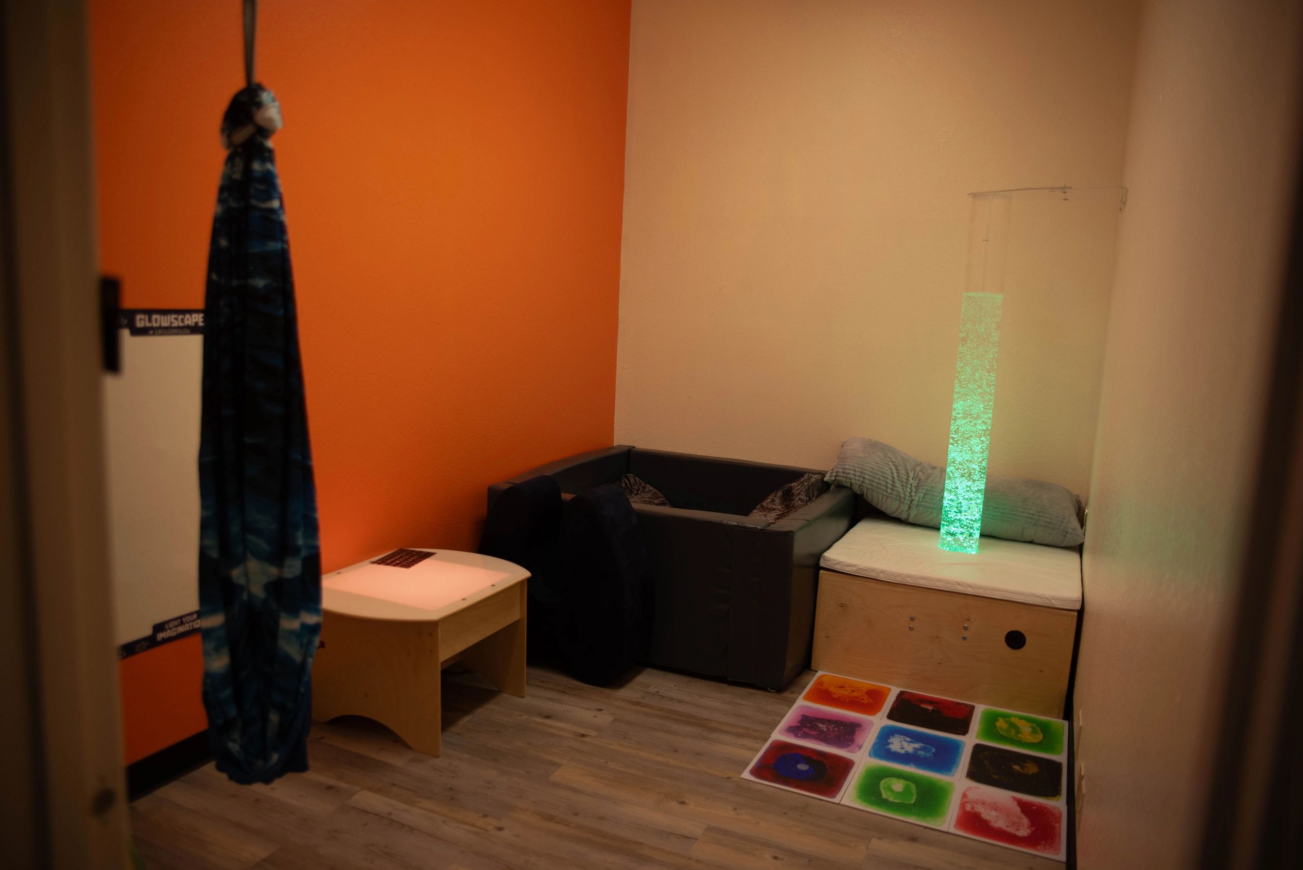 Modern play space with orange accent wall and LED lighting